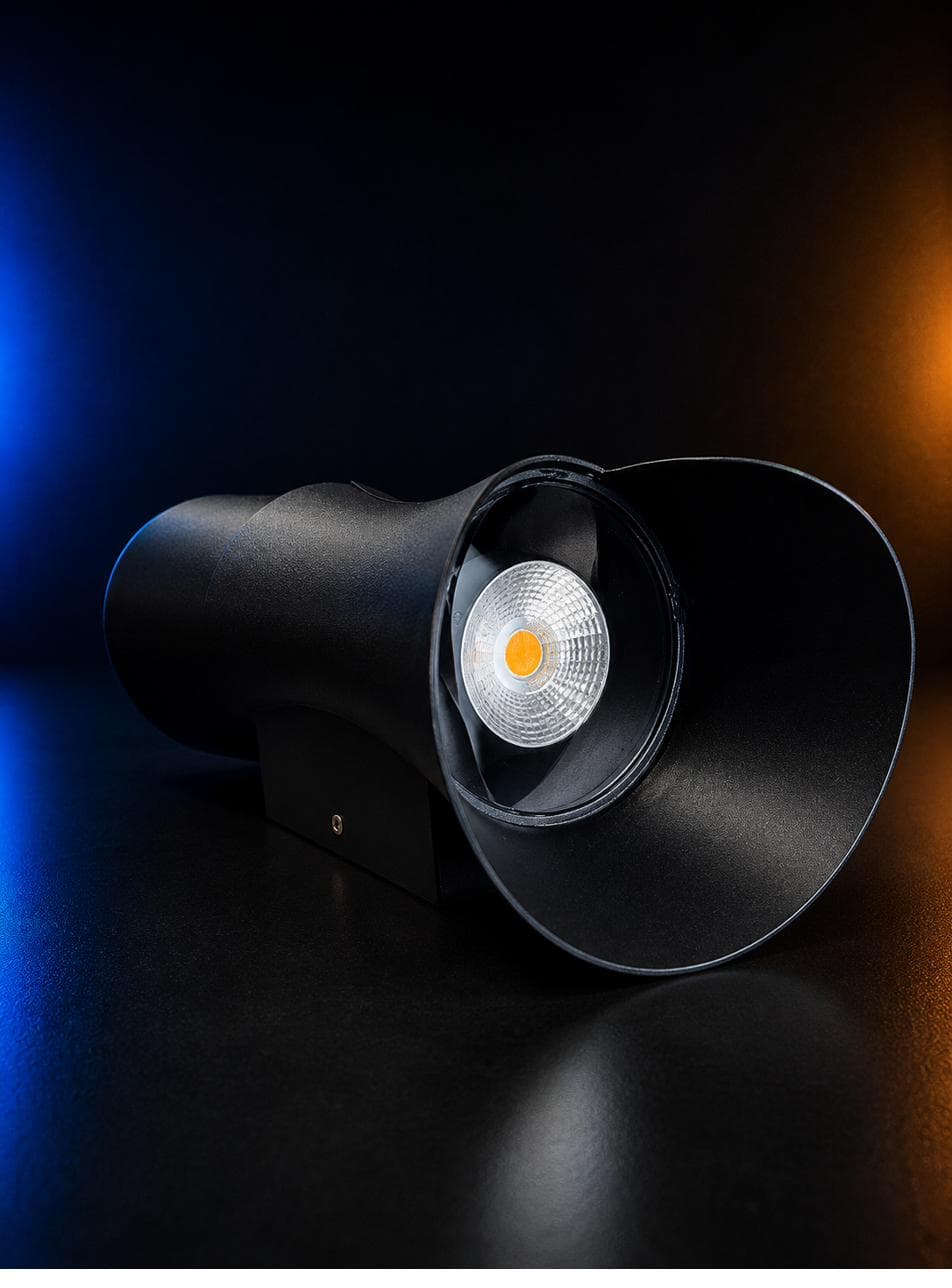 S-Curve Wall Light — black cylindrical wall light flaring into a curved hood